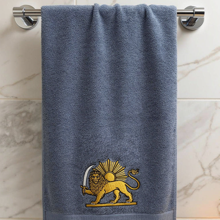 A blue-gray hand towel with a gold embroidered lion-sun logo